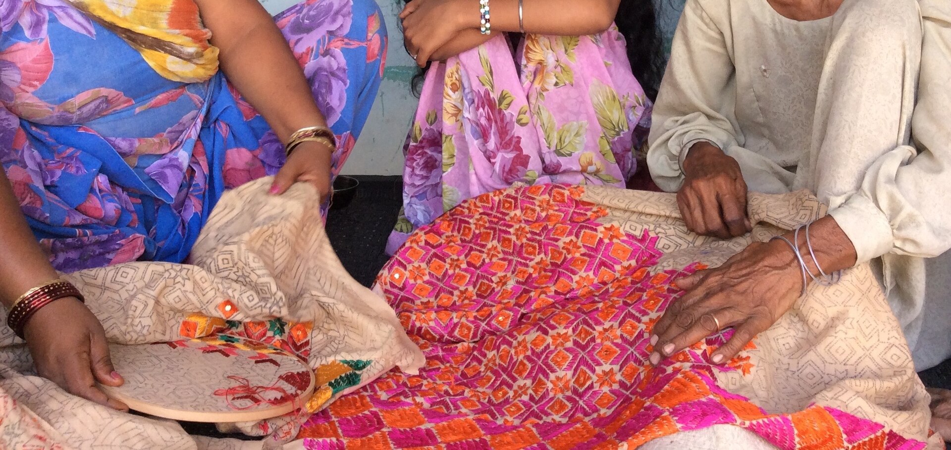 Women embroidering traditional Phulkari textiles in Punjab
